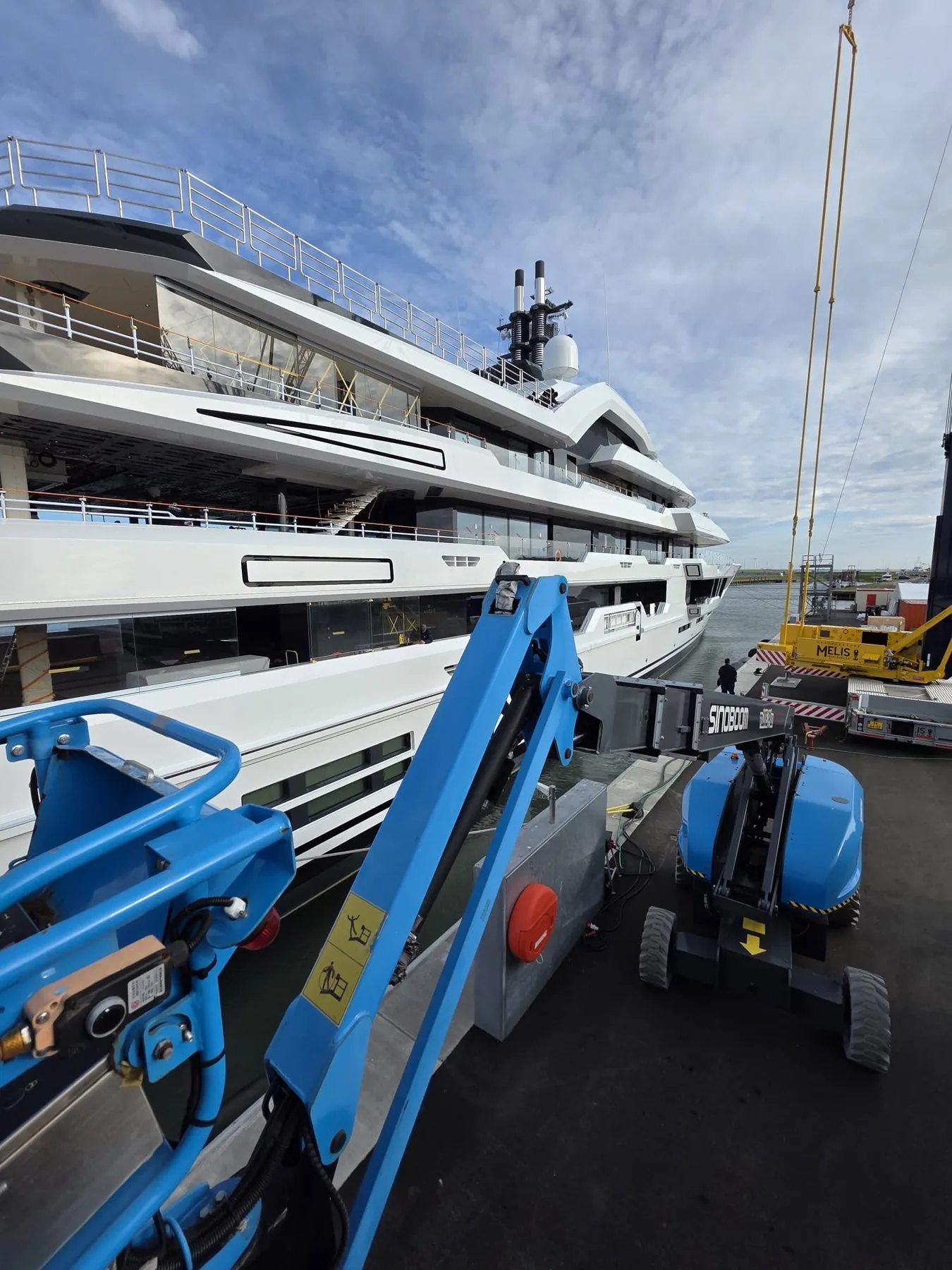 Shipyard with work platform beside a yacht