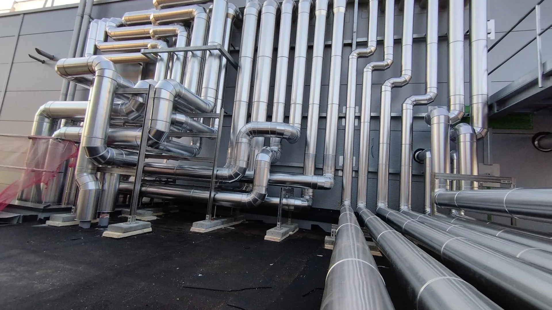 Industrial pipework installed on an exterior plant wall